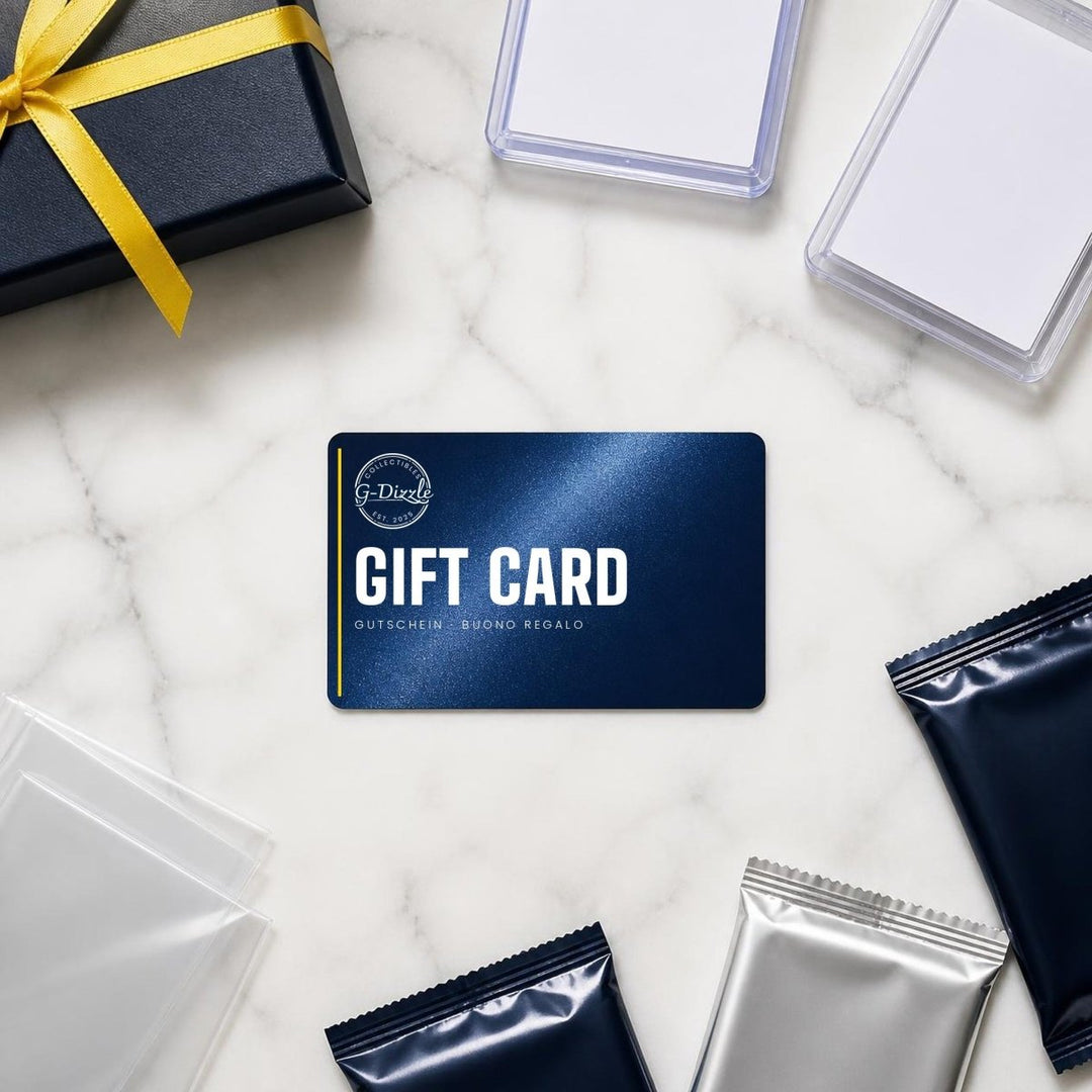 G-Dizzle Collectibles gift card on white marble with toploaders, penny sleeves and trading card packs
